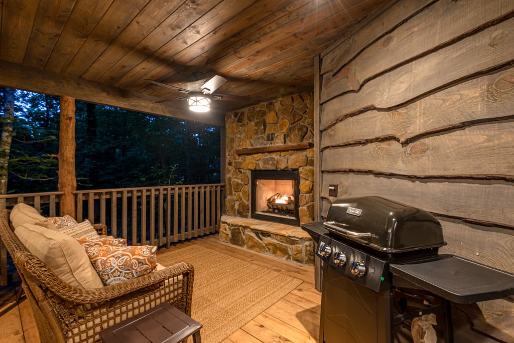 Covered back porch with grill, fireplace, and couch