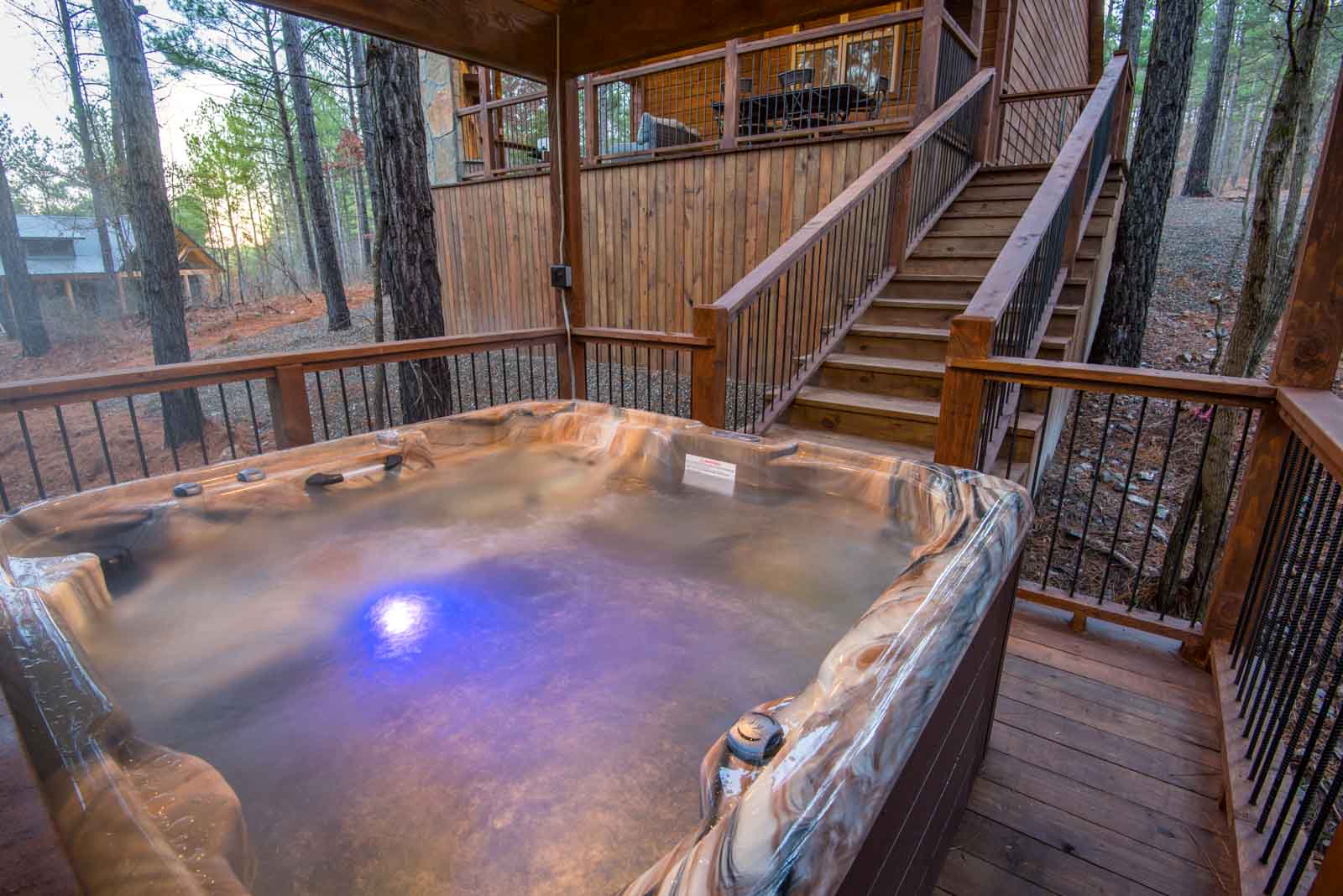Covered hot tub on downstairs deck in back