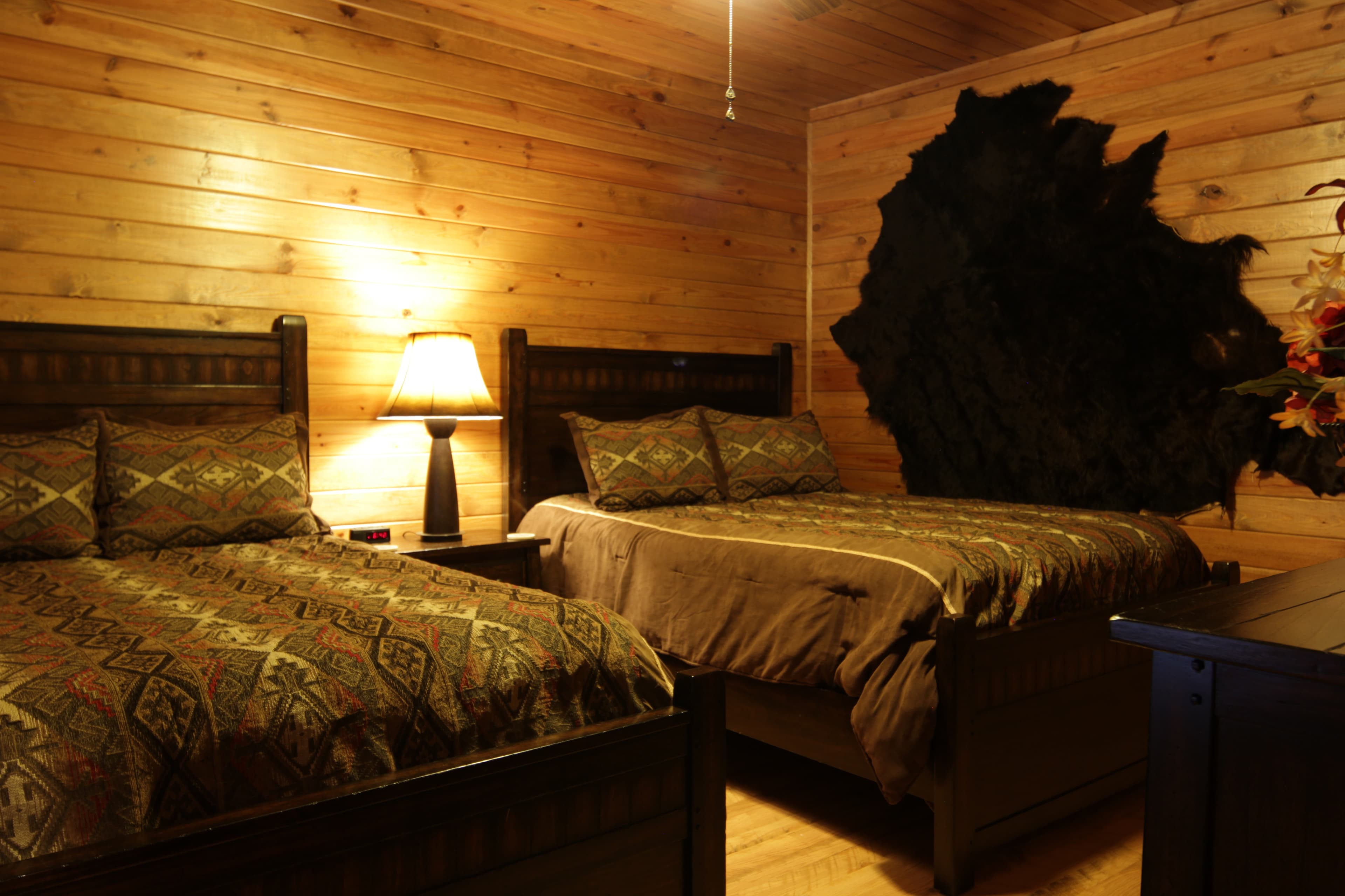 2nd bedroom with 2 beds, table and lamp