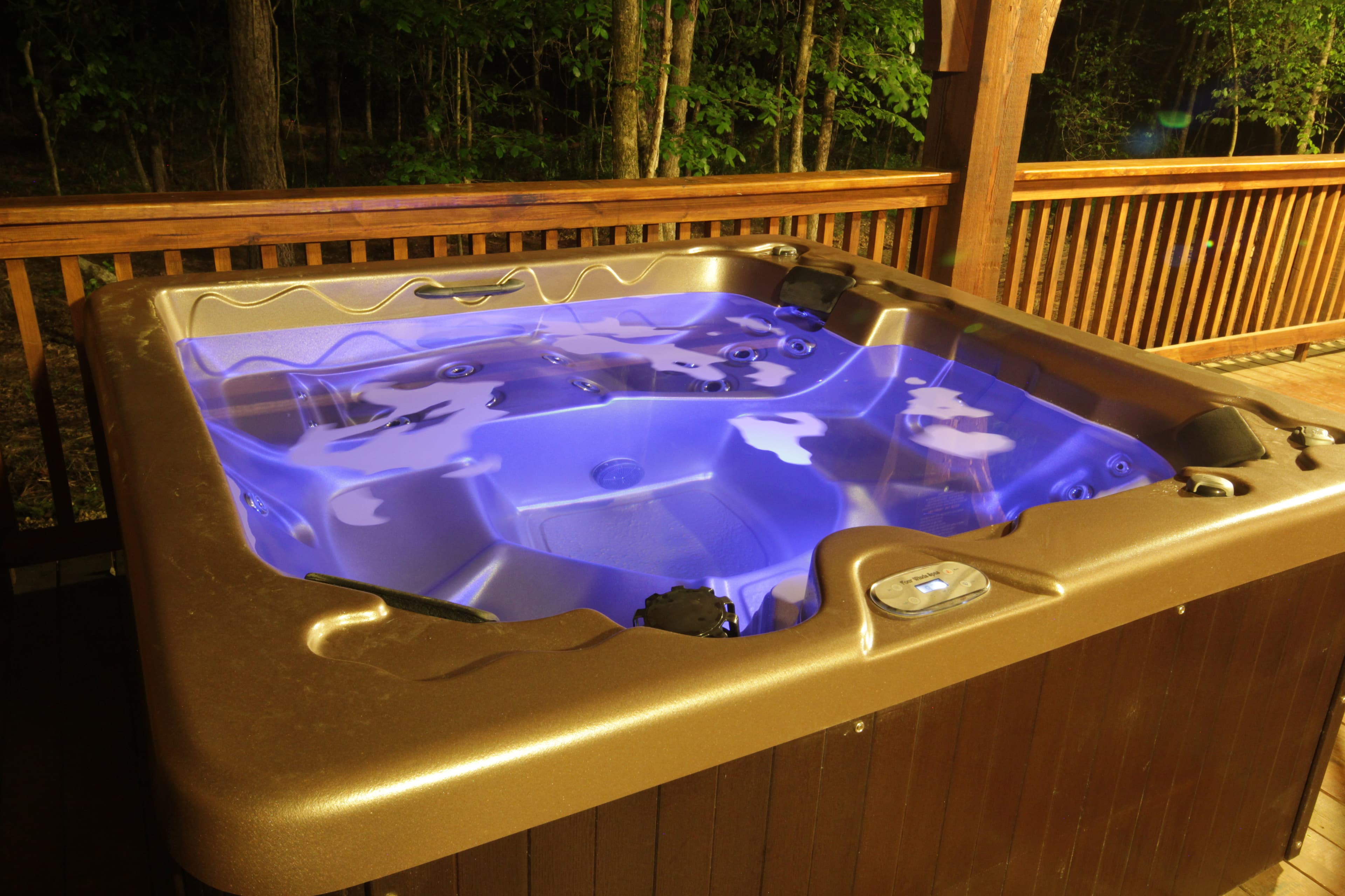 Hot tub on covered wooden back patio