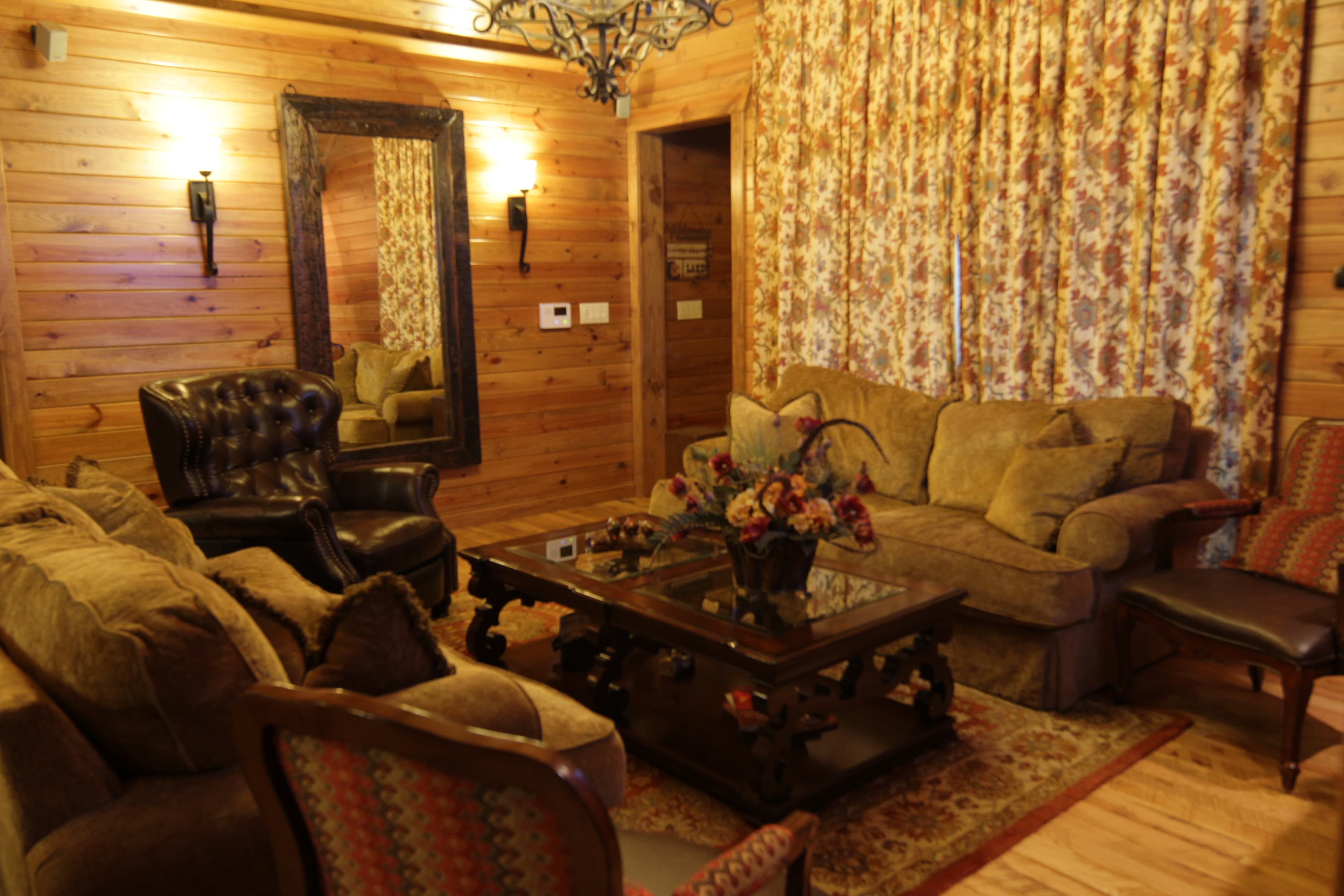 Open living room with coffee table, couches and chair