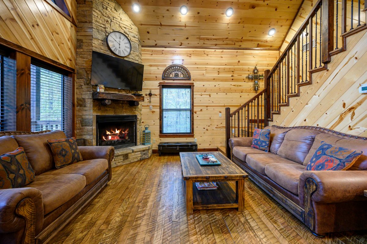 Open living area, couches, coffee table, and fireplace
