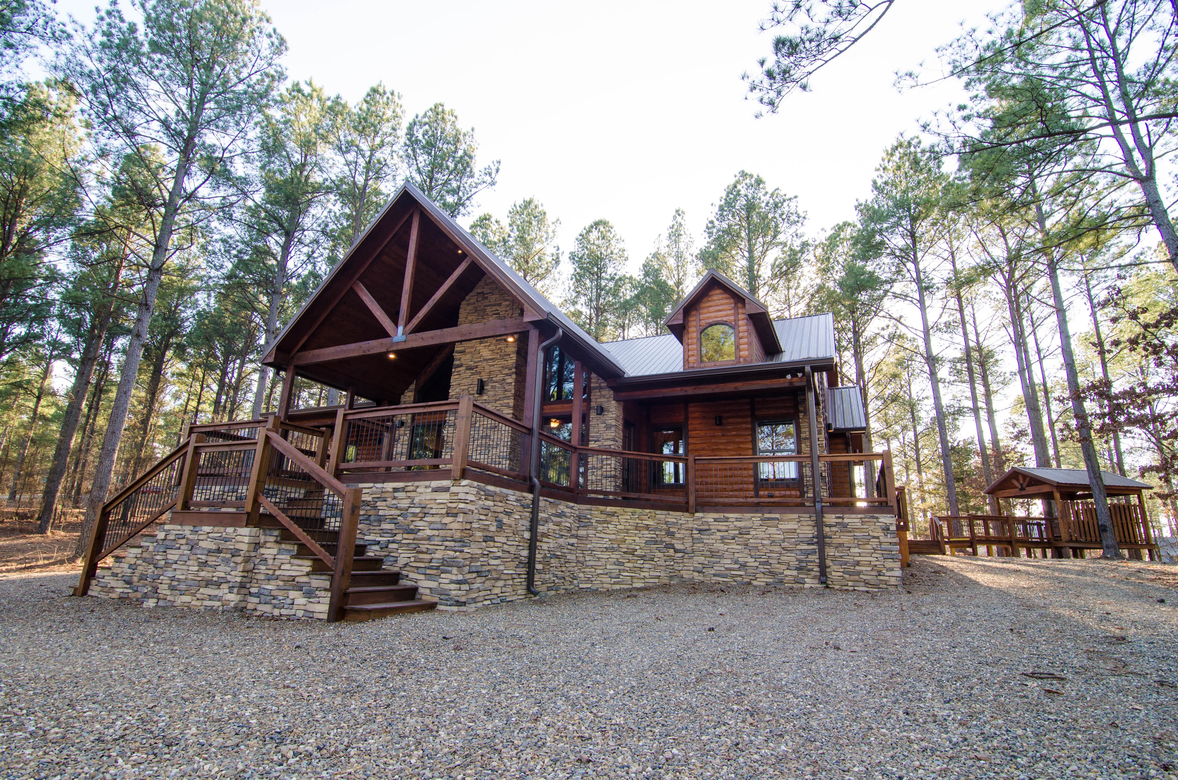 Front of log cabin with rock fireplace