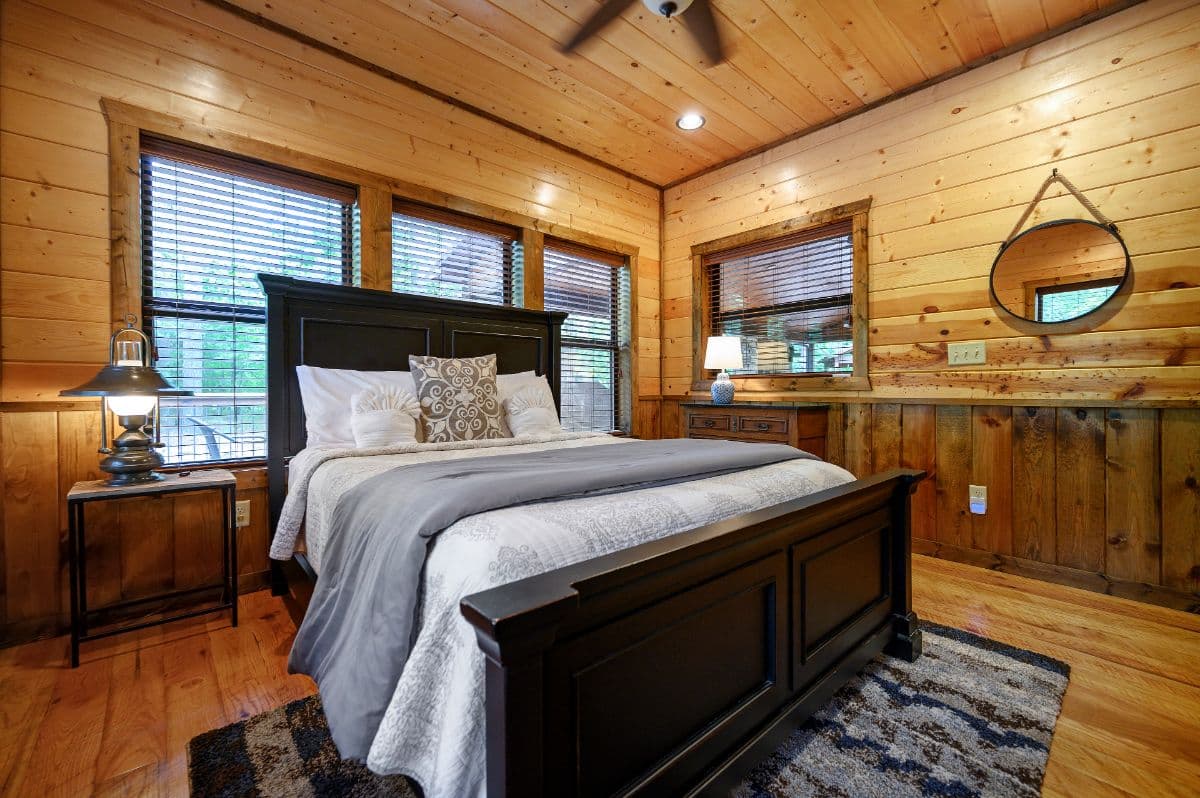 bedroom with side table and dresser, and mirror on wall