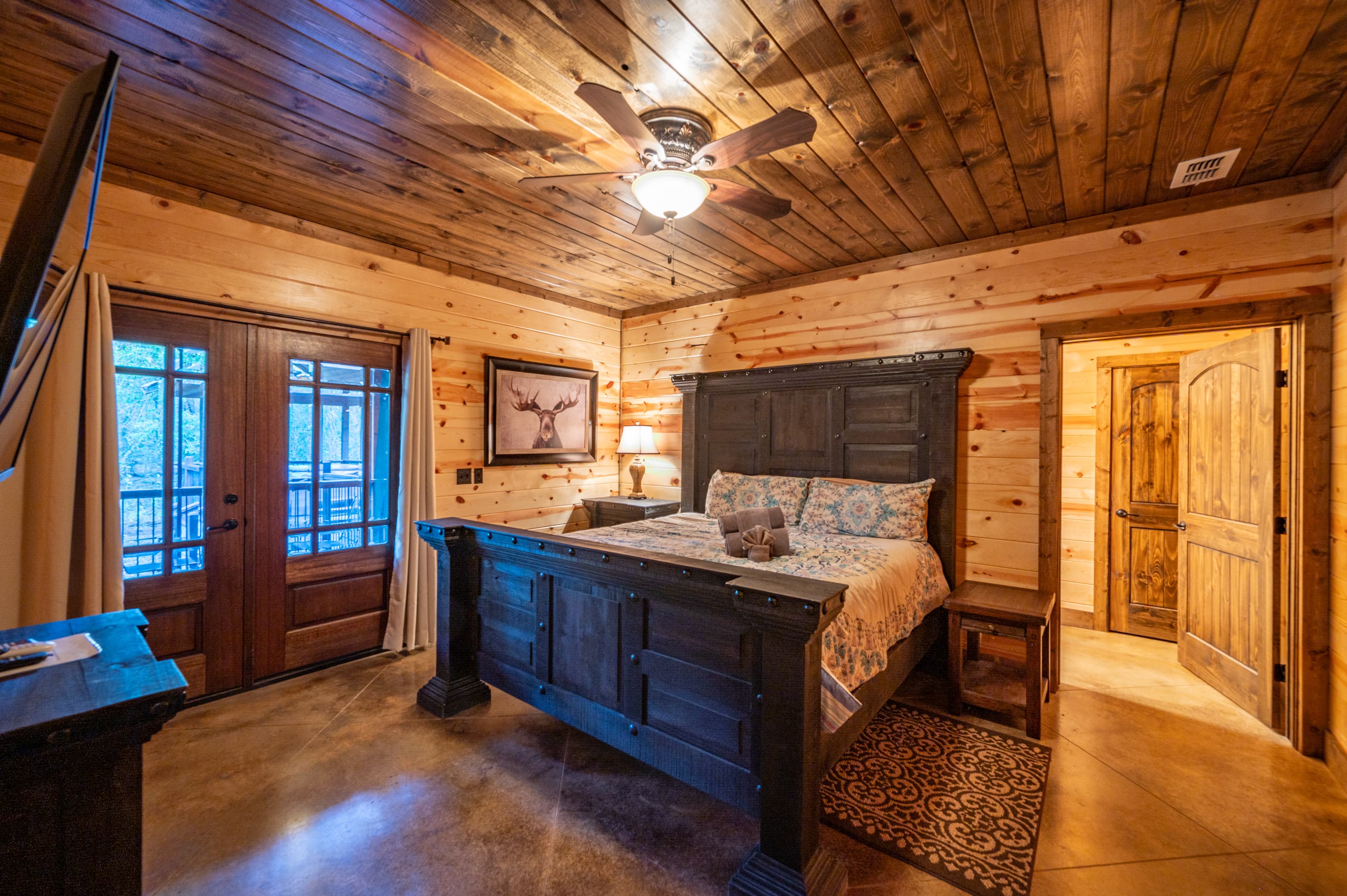 King bedroom with moose art on wall