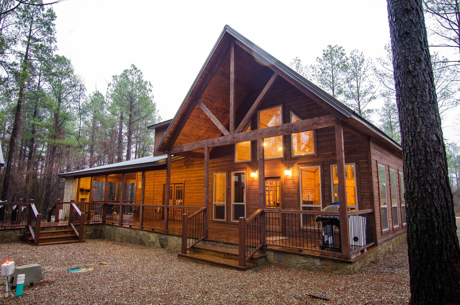 Back of cabin with gravel backyard