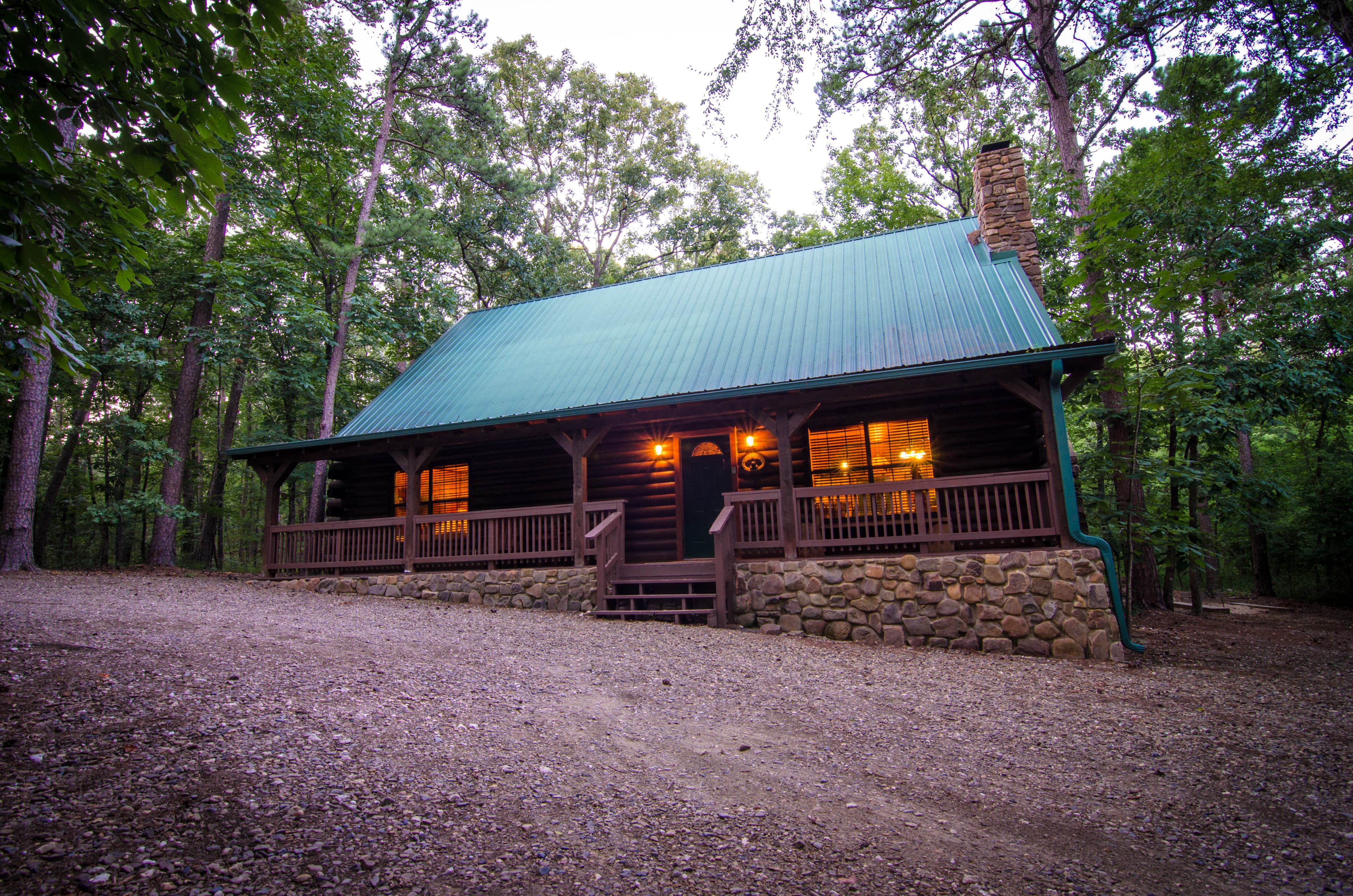 Front of log 1-story cabin with about 4 steps to get into cabin