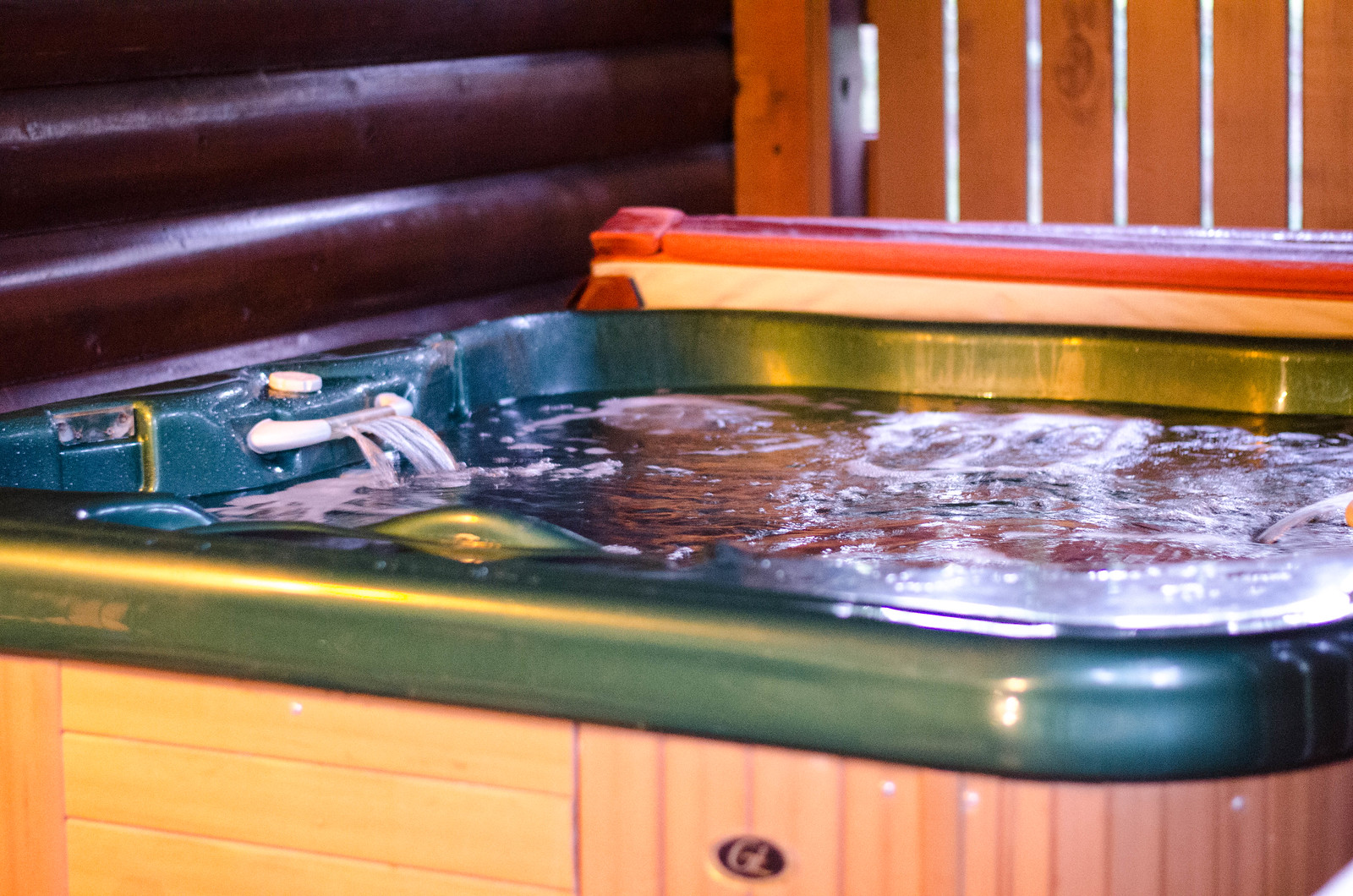 Hot tub on back covered wooden porch