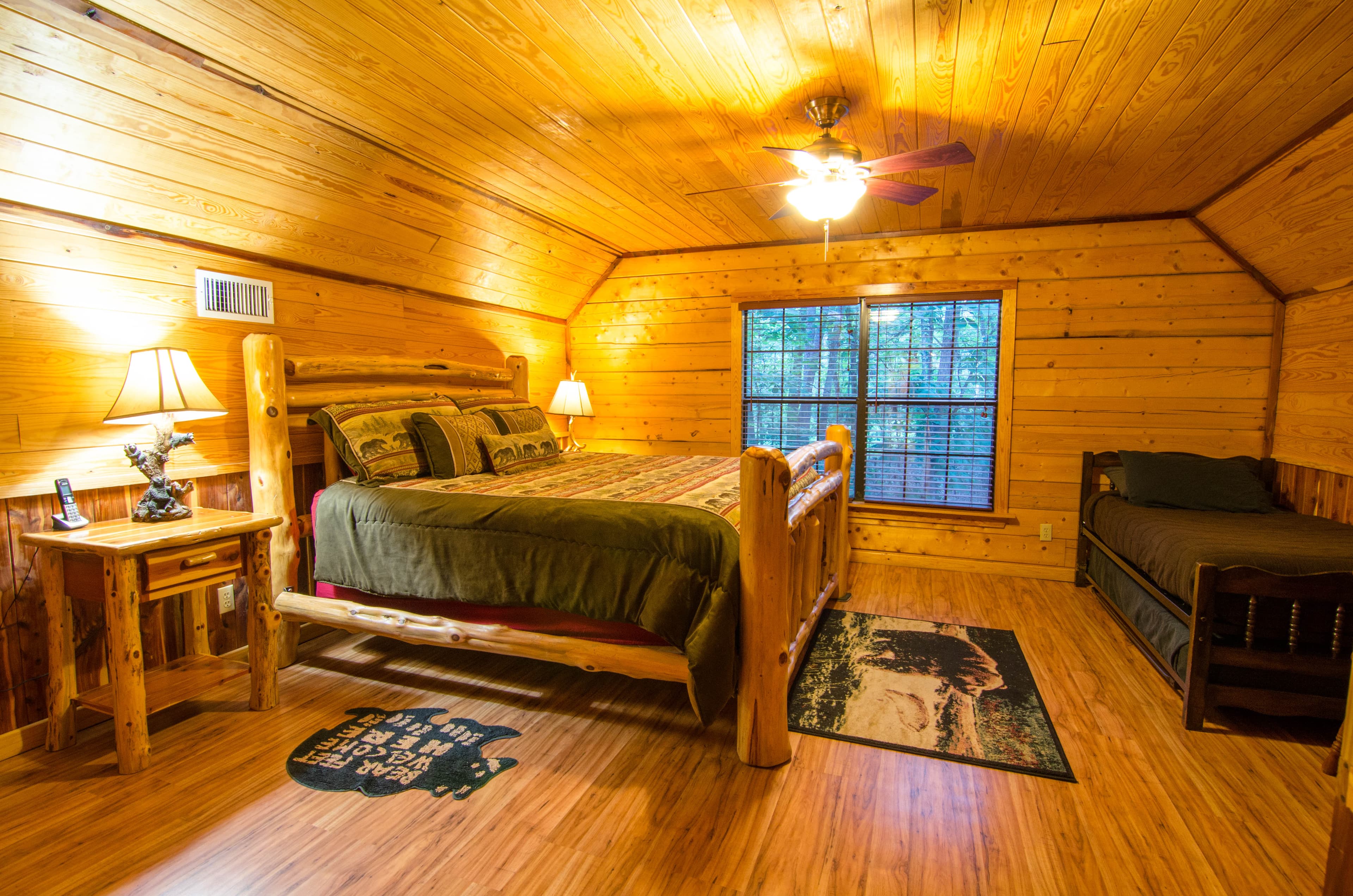 Upstairs King bedroom with side tables, lamps, and a twin bed