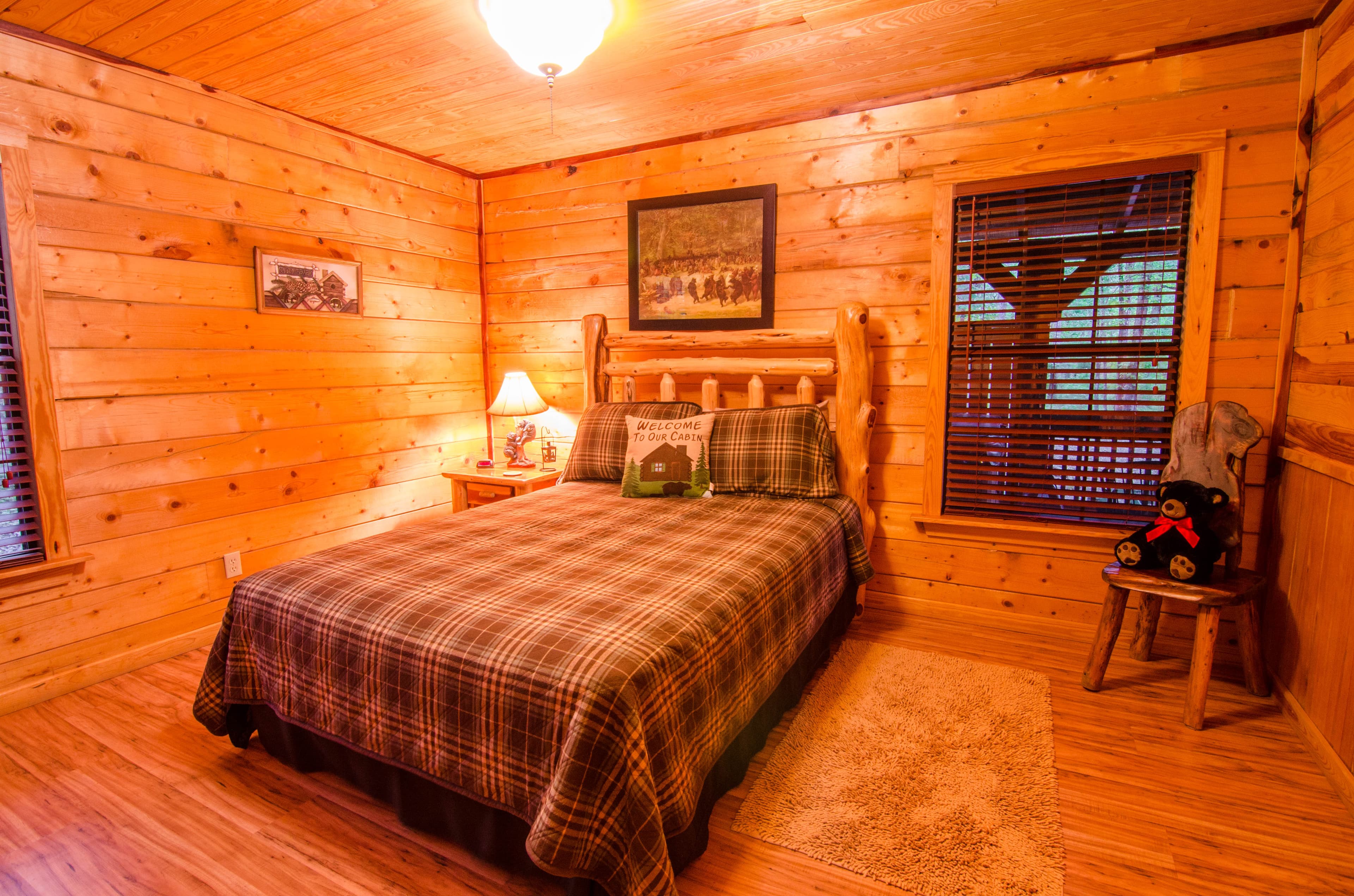 Queen back bedroom with side table, lamp, and chair