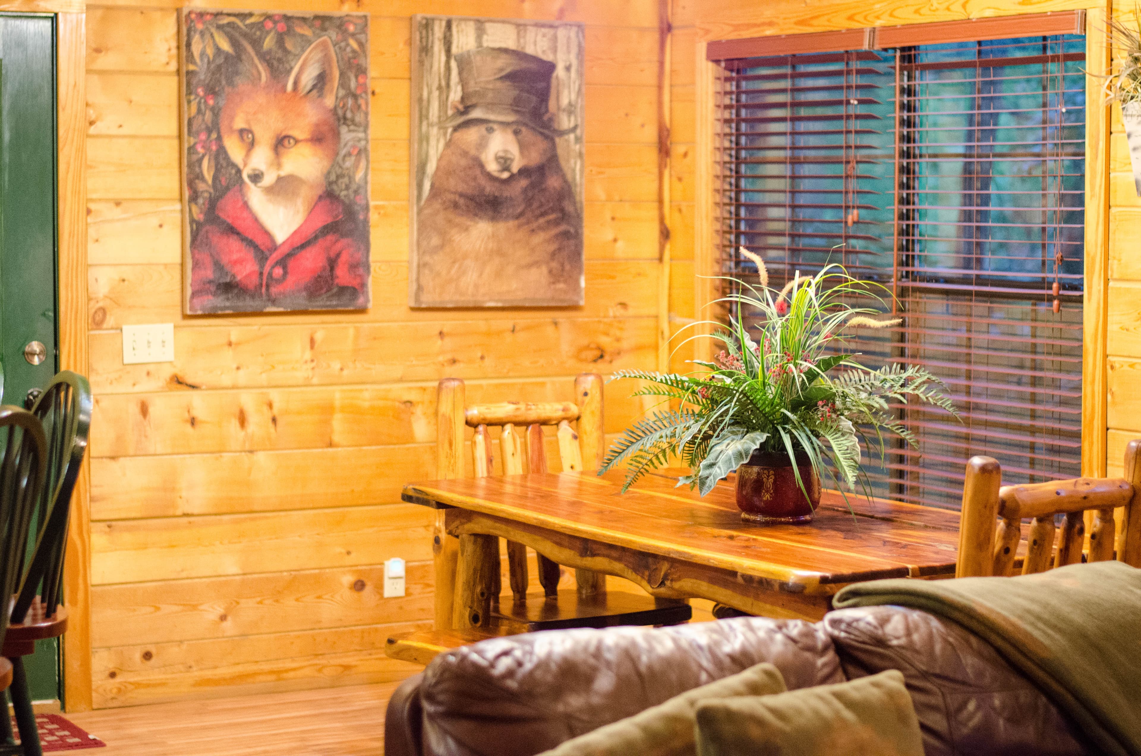 Open dining room with forest animals art on wall