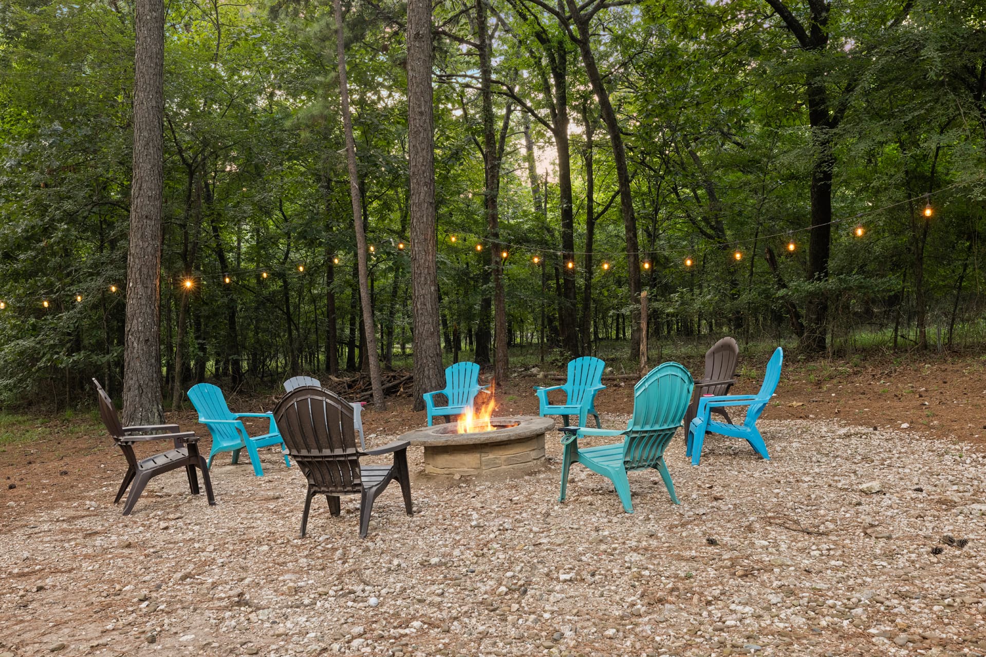 fire pit with 9 chairs and a big back yard