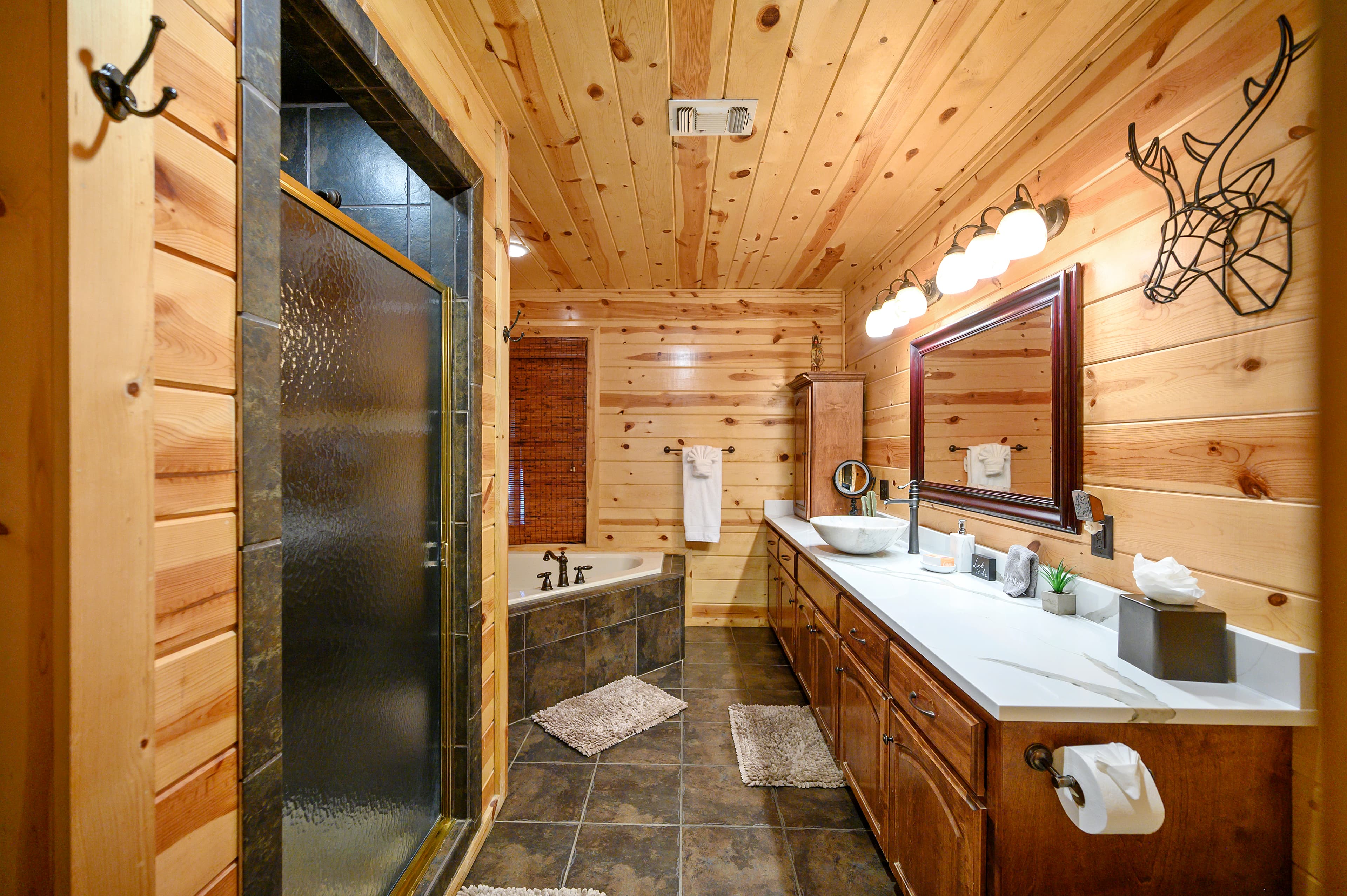 Master bathroom with tub, shower, and 2 modern sinks