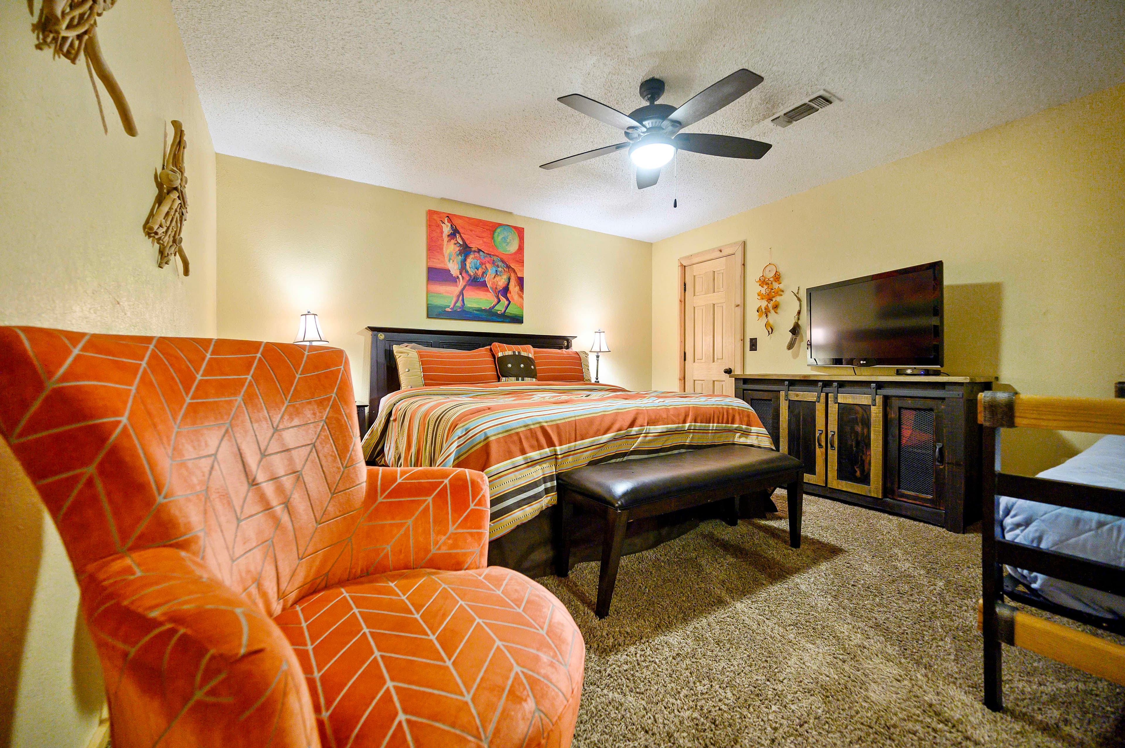 Downstairs king bedroom with chair and twin bed