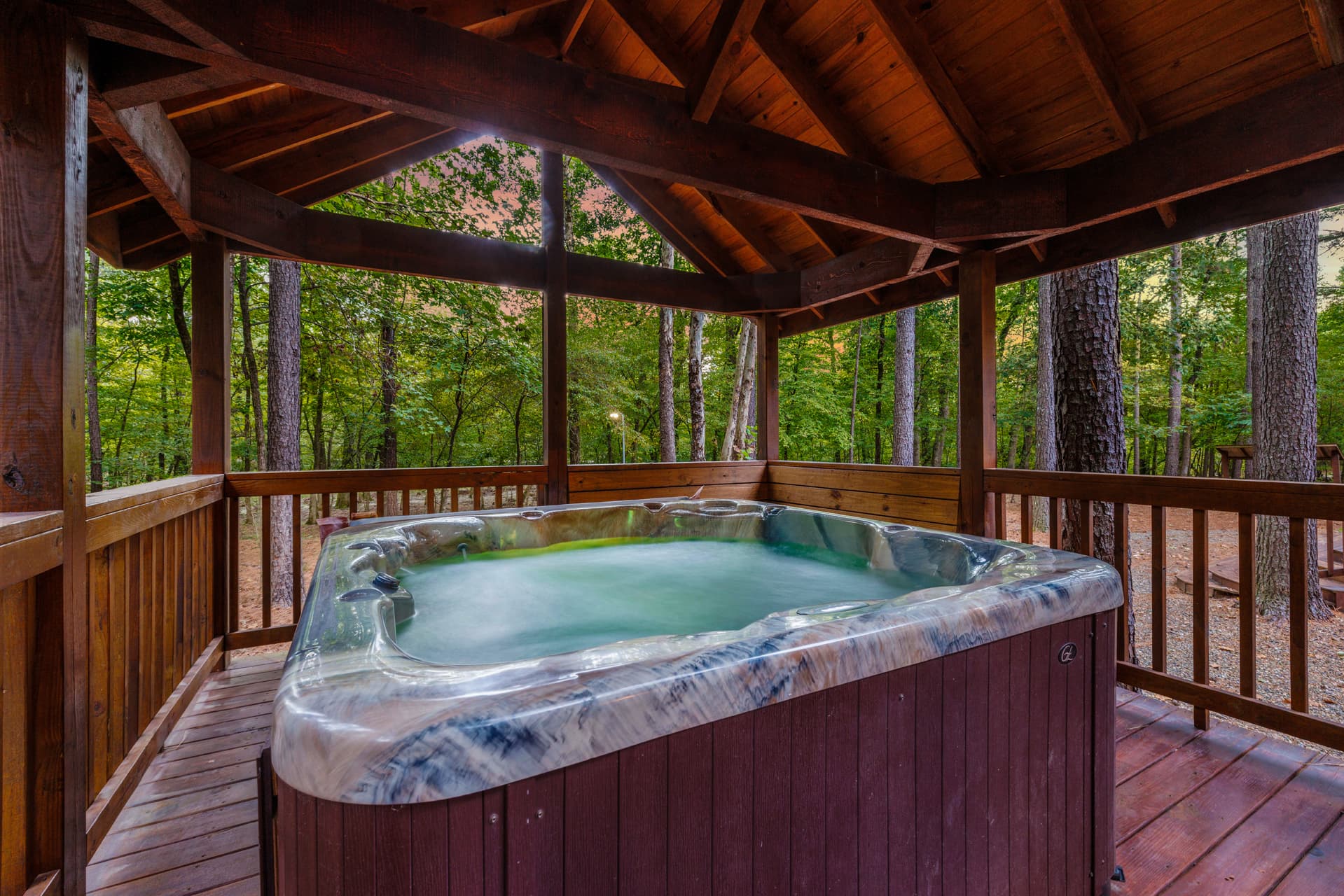 large hot tub on covered wooden deck