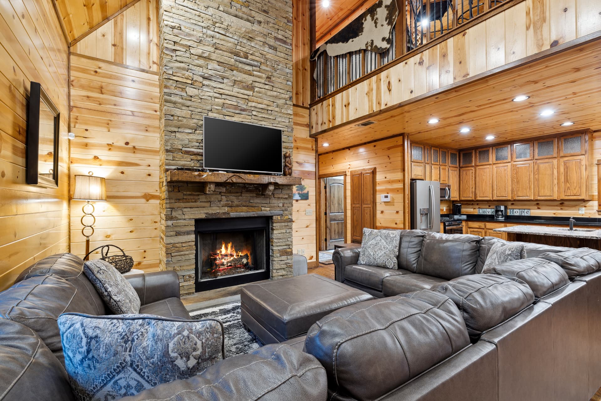1st living room with 3 couches and fireplace, tv