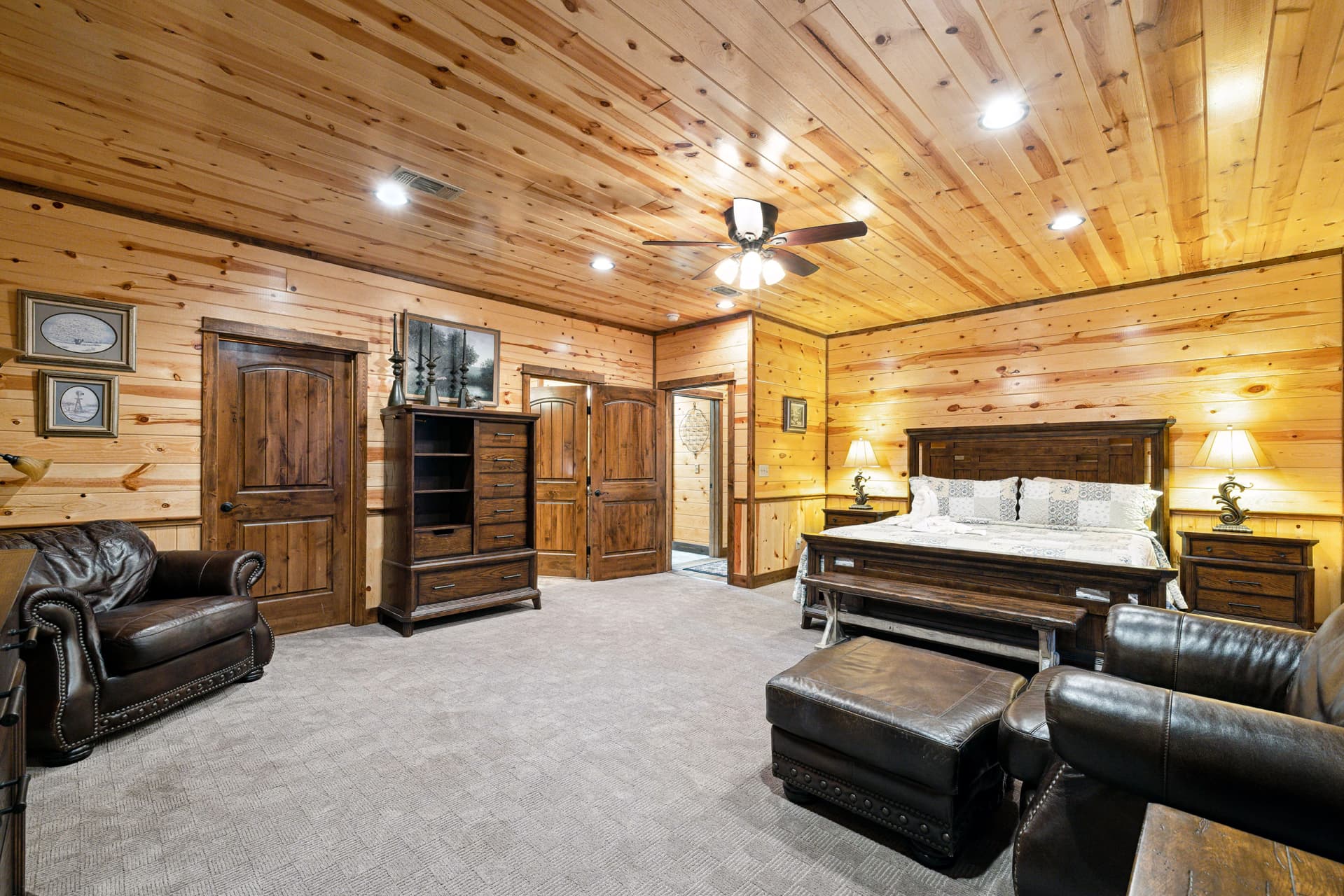 king bedroom with chairs and tv