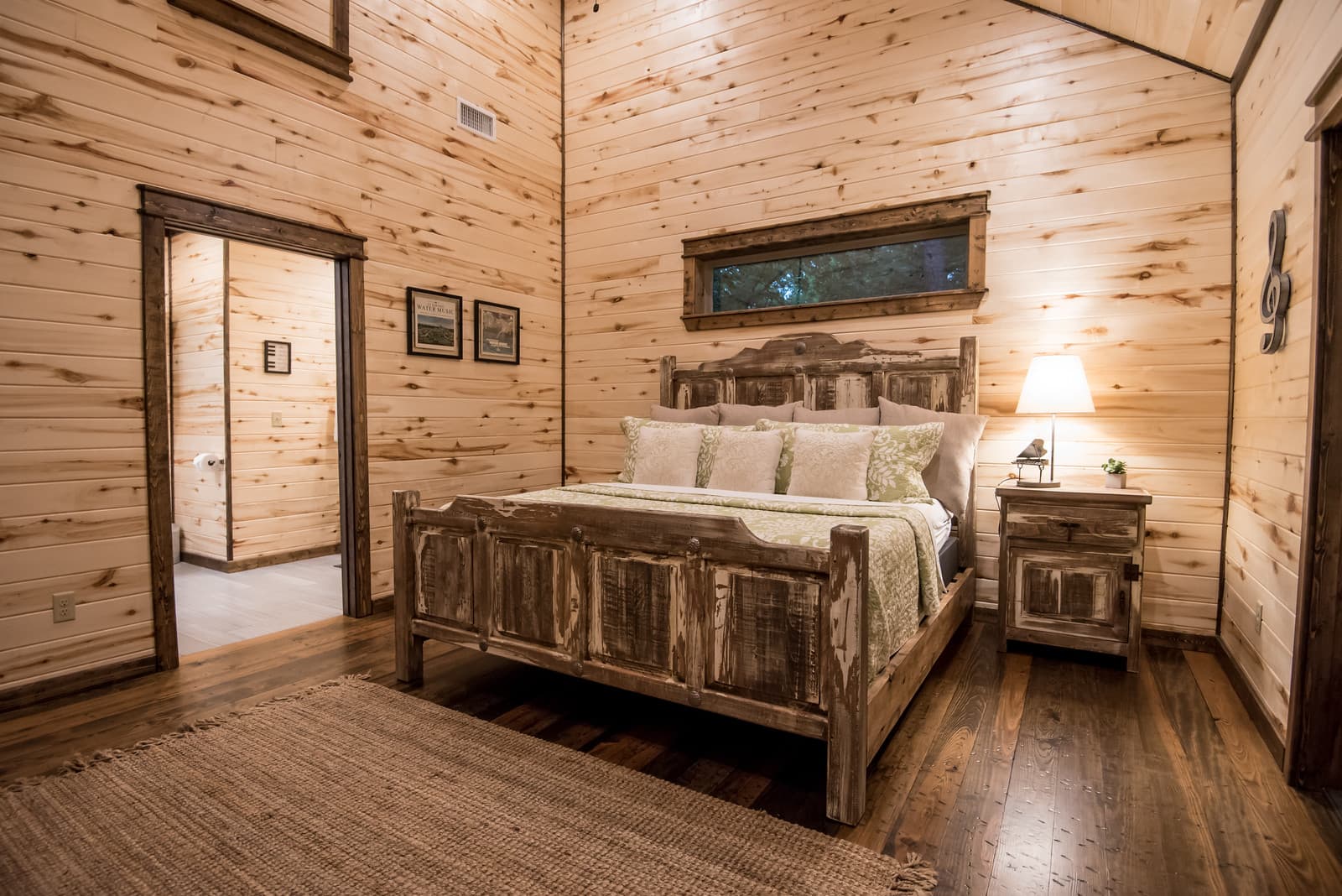 Back left King bedroom with side table, lamp, and attached full private bathroom