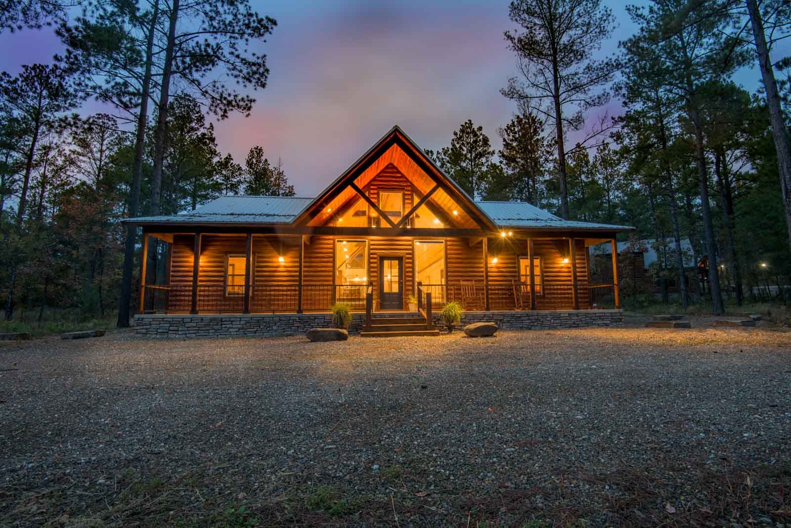 Open living area with couches, chair, coffee table, fireplace, TV