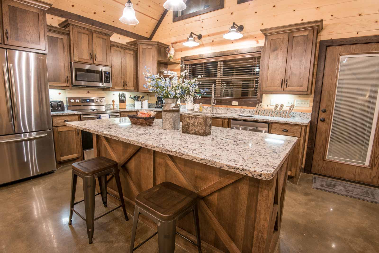 Modern open kitchen with an island and 2 stools