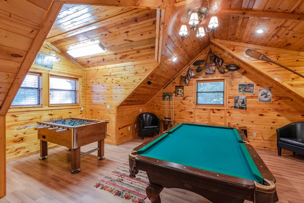 Upstairs game room above garage, pool table and foosball table