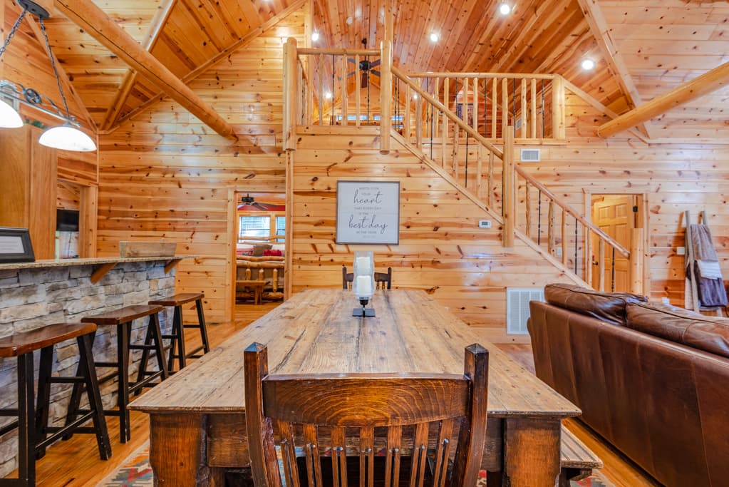 Large kitchen table in between the open kitchen and living room
