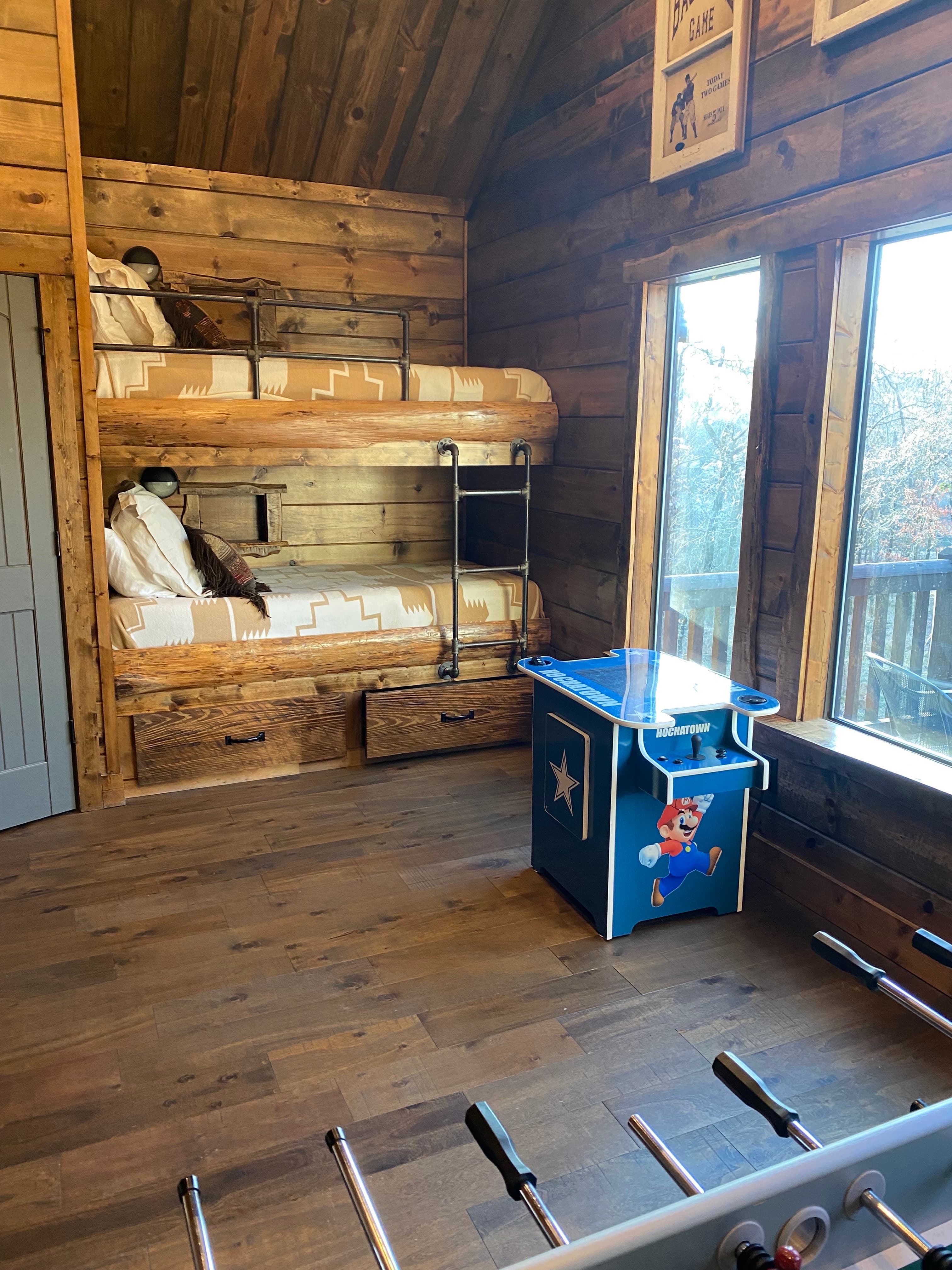 Loft Bedroom with a Set of Bunk Beds and Arcade Machine