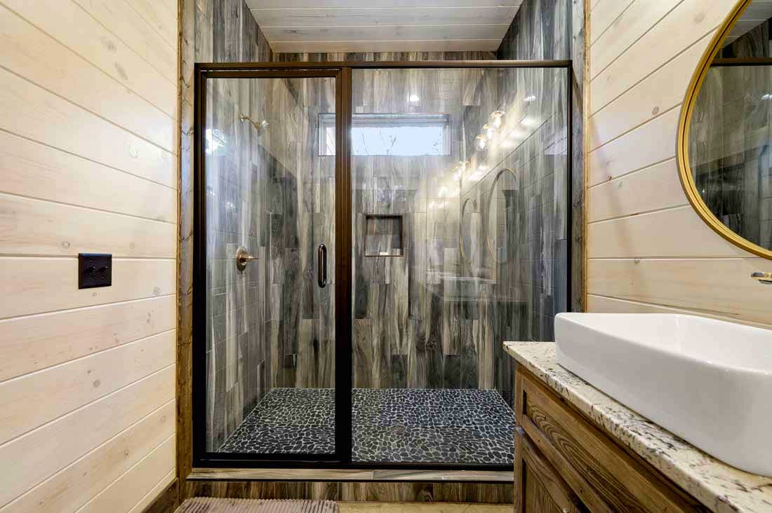 tile shower with rock floor