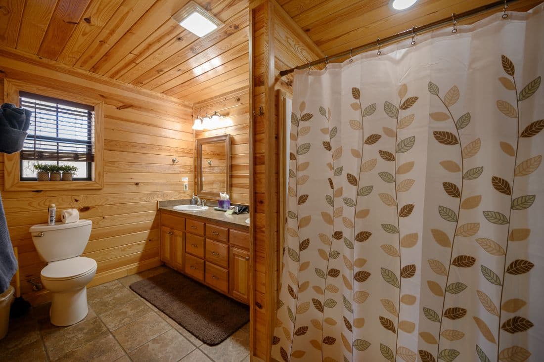 full bathroom with 2 sinks and a tub/shower combo
