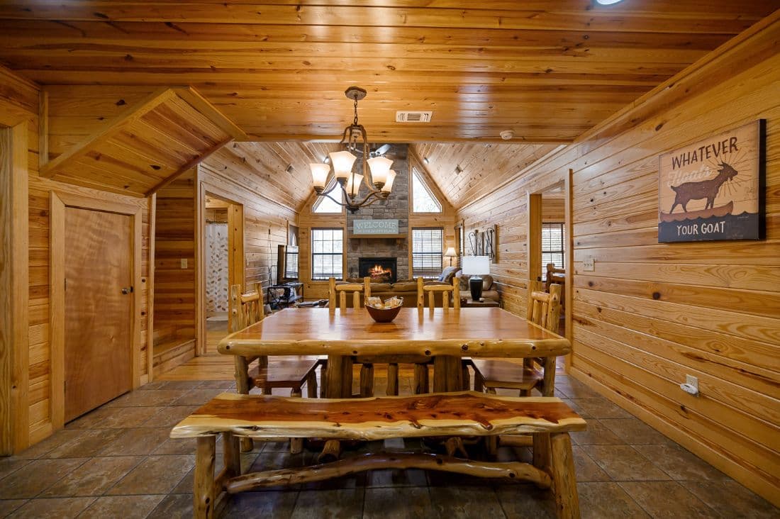 Dining table in open dining room with goat art on wall