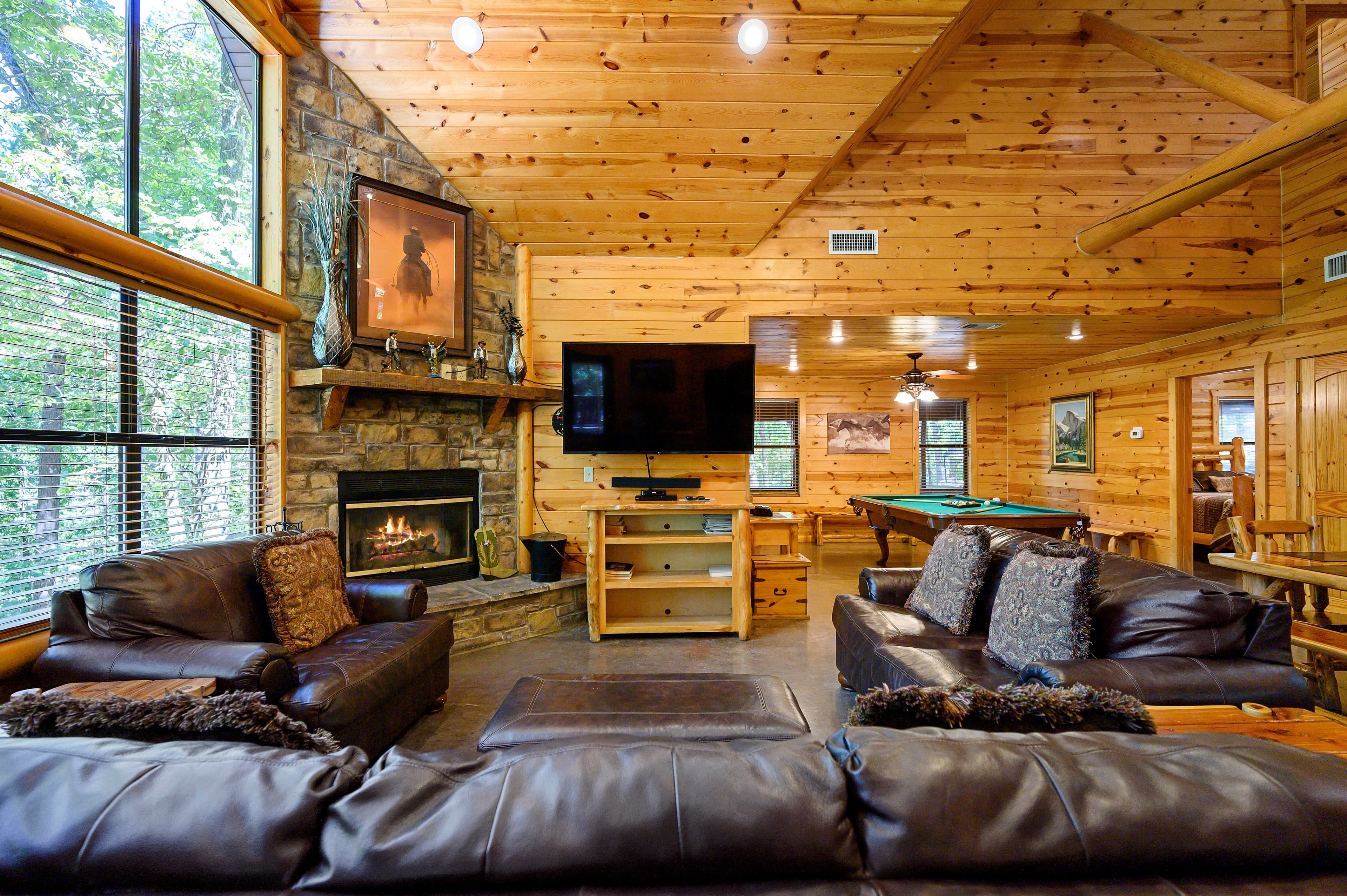 Living room and dining room with fireplace and couches