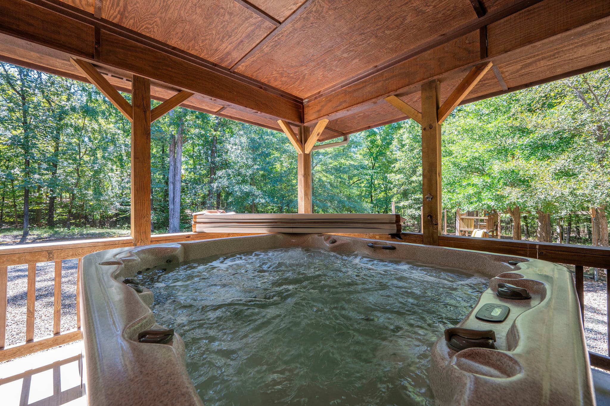 large hot tub on covered deck