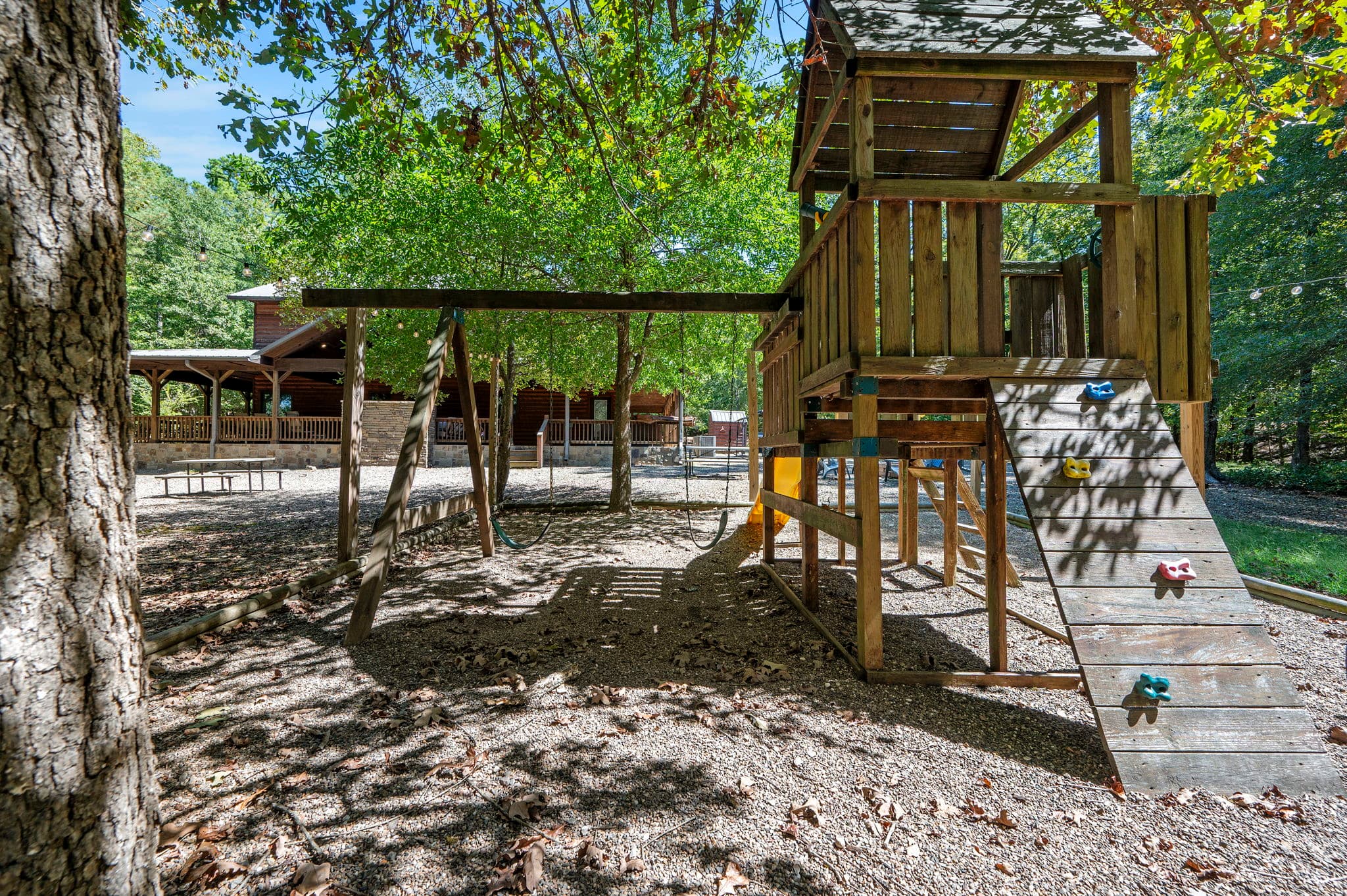 playground in backyard with a slide and swings