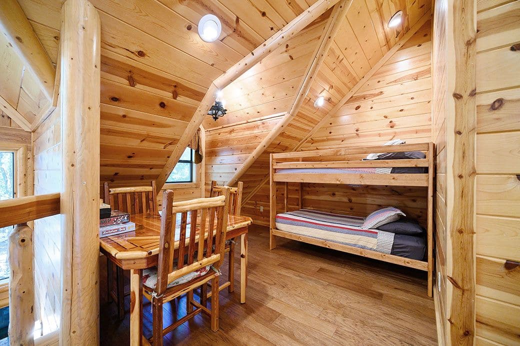 Loft with table, 3 chairs, and a bunk bed