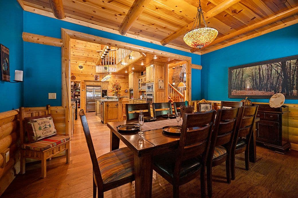 Kitchen Table with 10 chairs and a teal blue wall