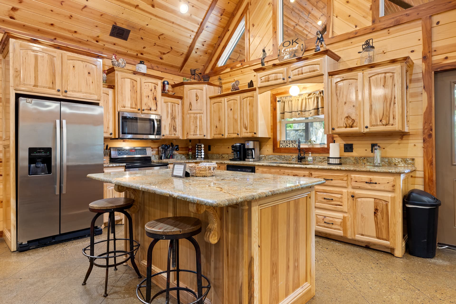 kitchen includes oven, microwave, and full fridge and bar seating