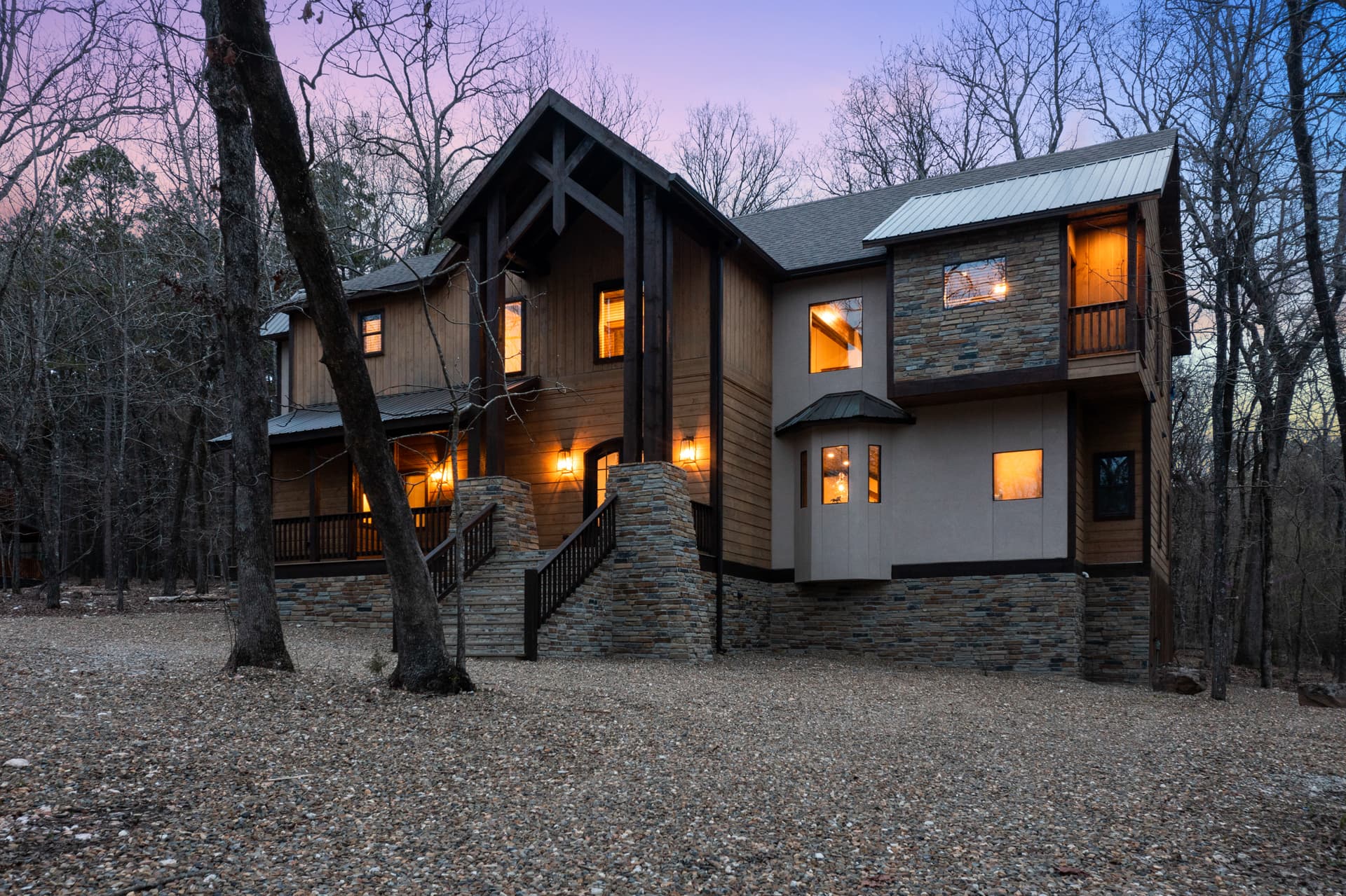 Front of log 2 story cabin with large driveway space