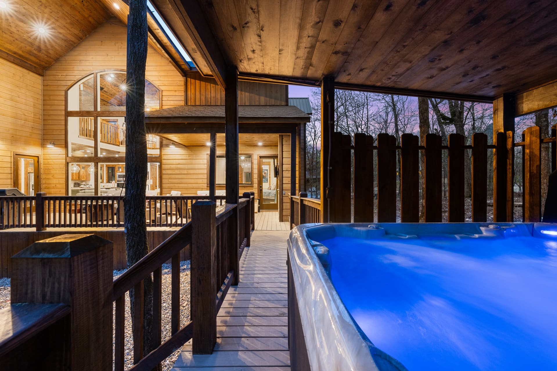 large hot tub, covered wooden patio