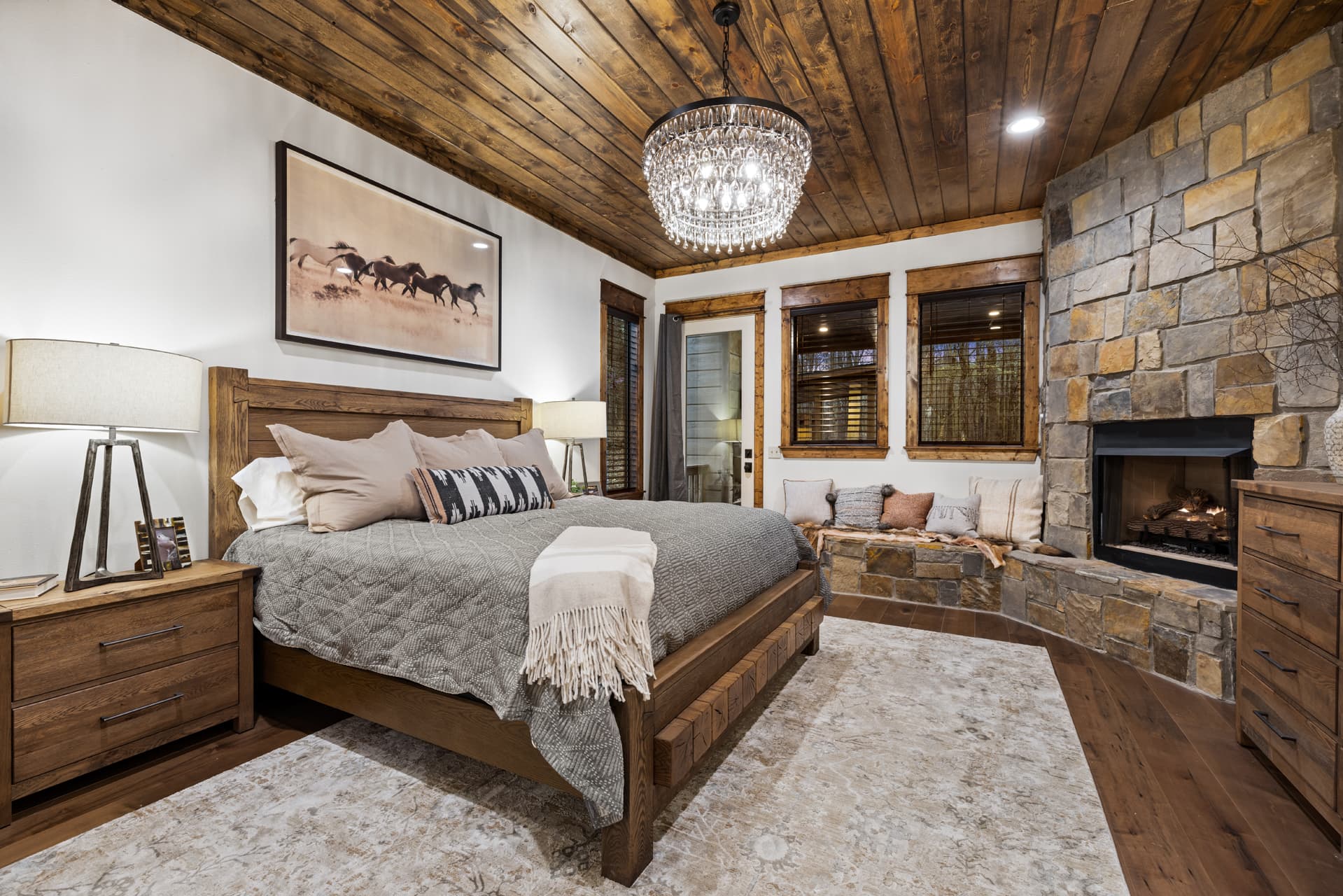king downstairs bedroom with fireplace