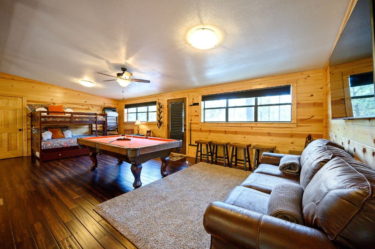 Upstairs loft with couch, tv, pool table, and bunk bed