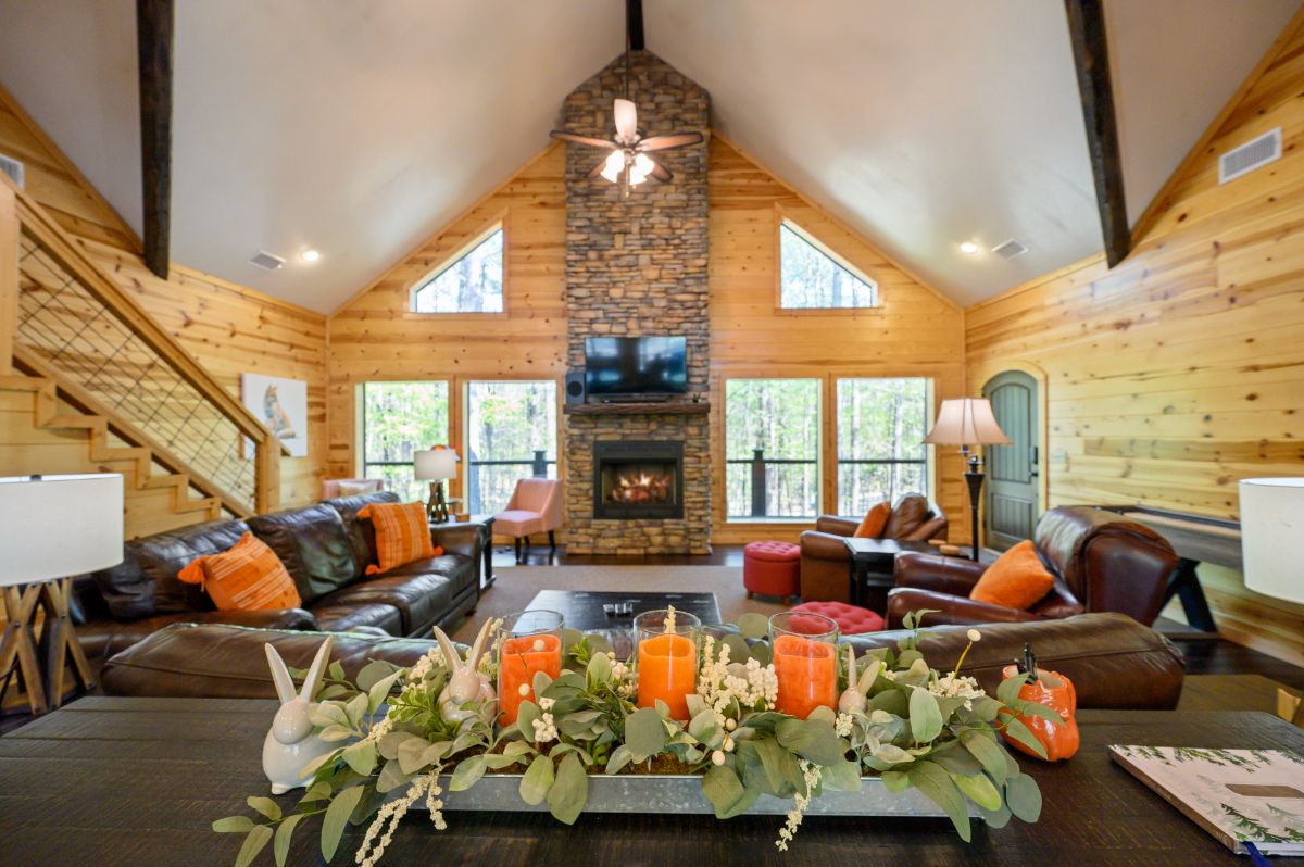 Inside open living room with rock fireplace and TV