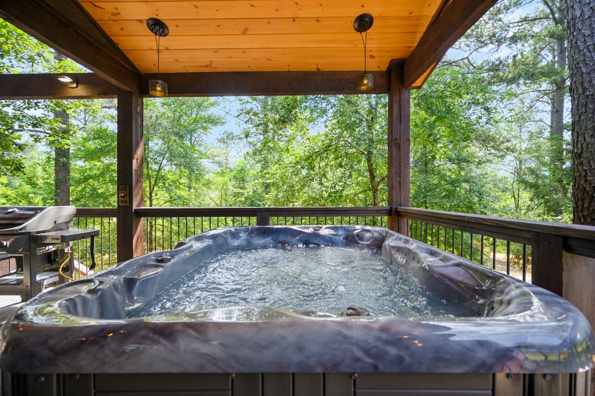 hot tub and grill on covered patio