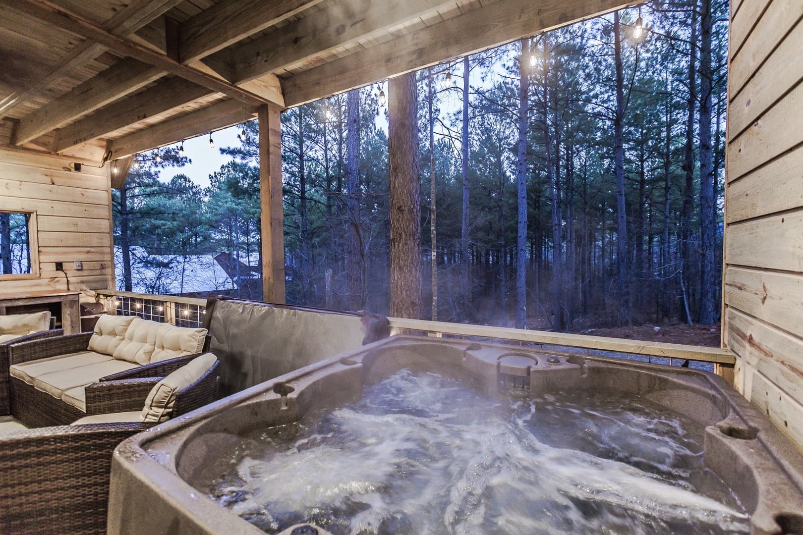Covered patio with hot tub and couch
