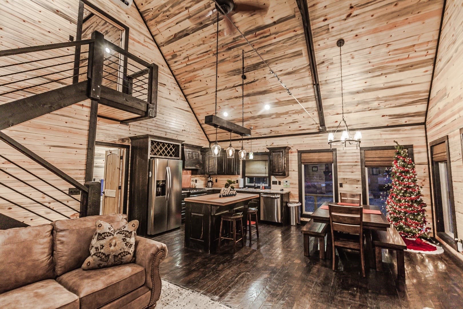 Open living room with stairs leading up to loft