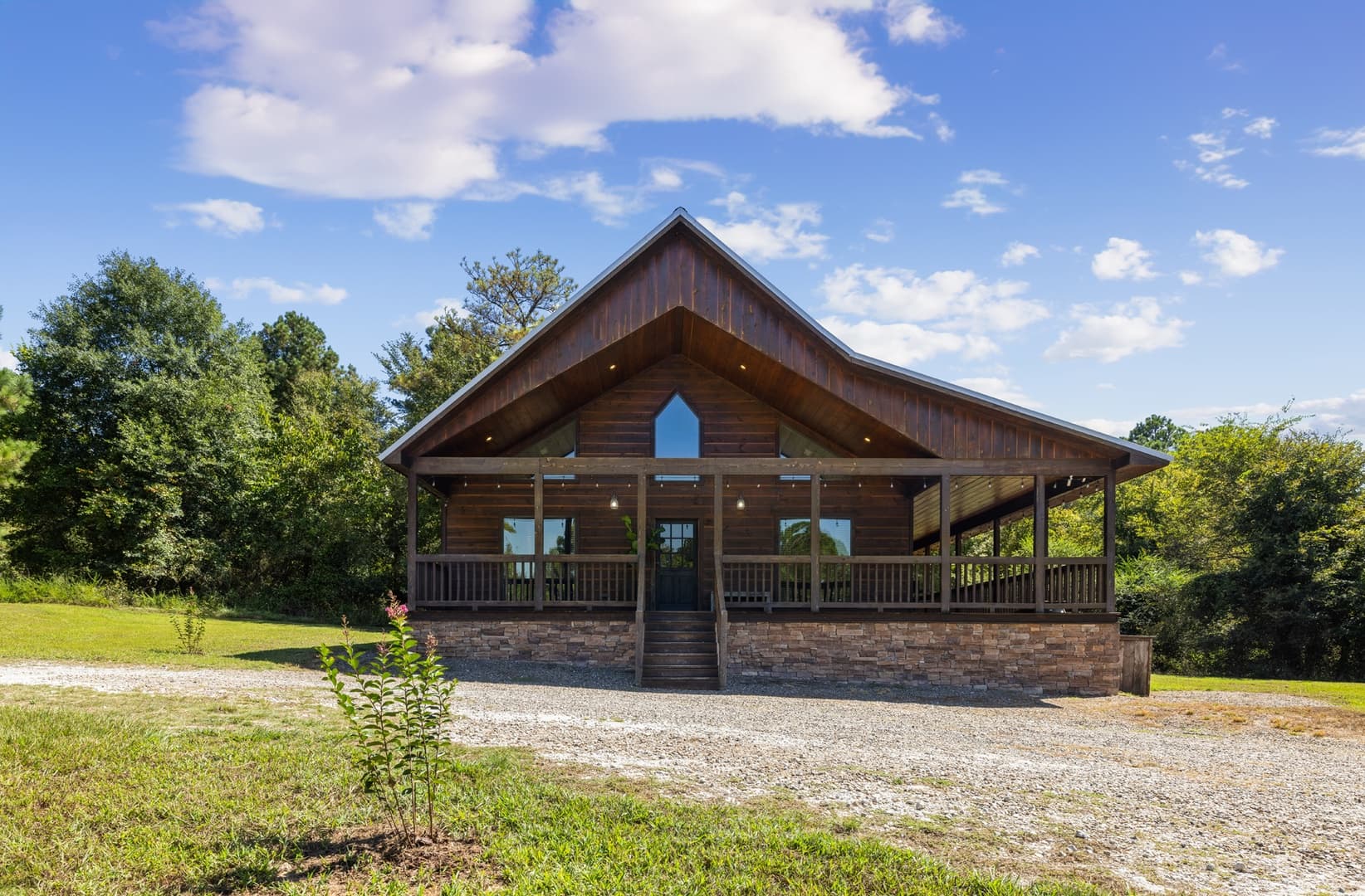 Front of log cabin with circle driveway