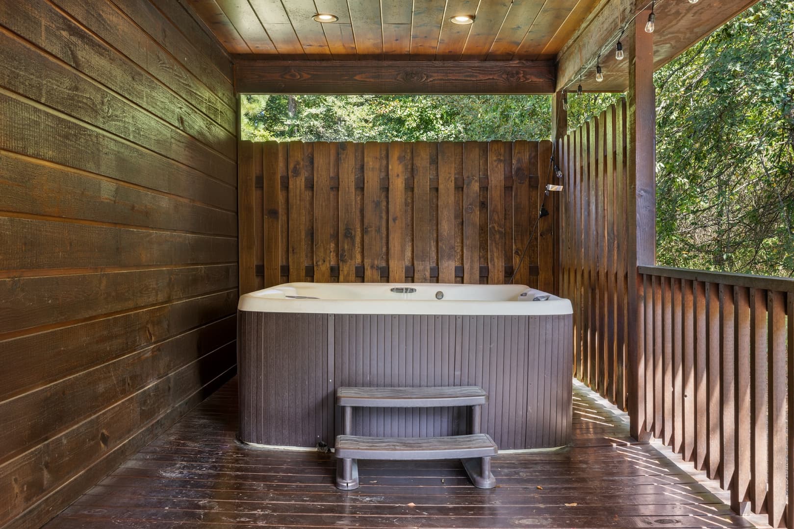 hot tub on covered wooden deck