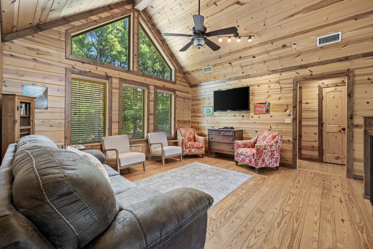 Game room loft with 4 chairs, a couch, and a TV