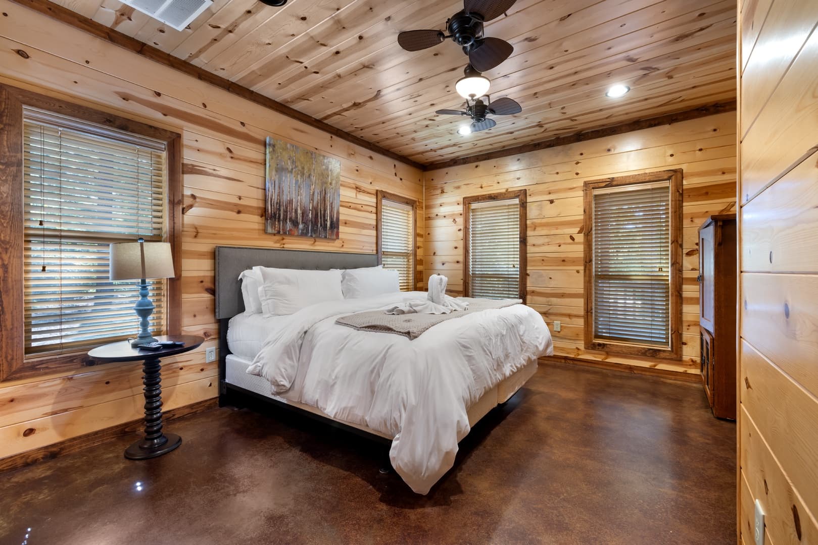 King bedroom, dresser, and a side table with lamp