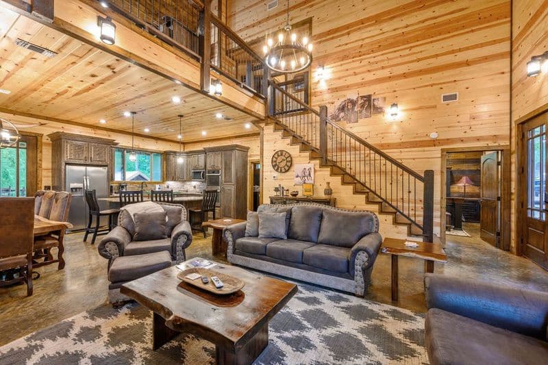 Open living room area with couches, coffee table, and a chair