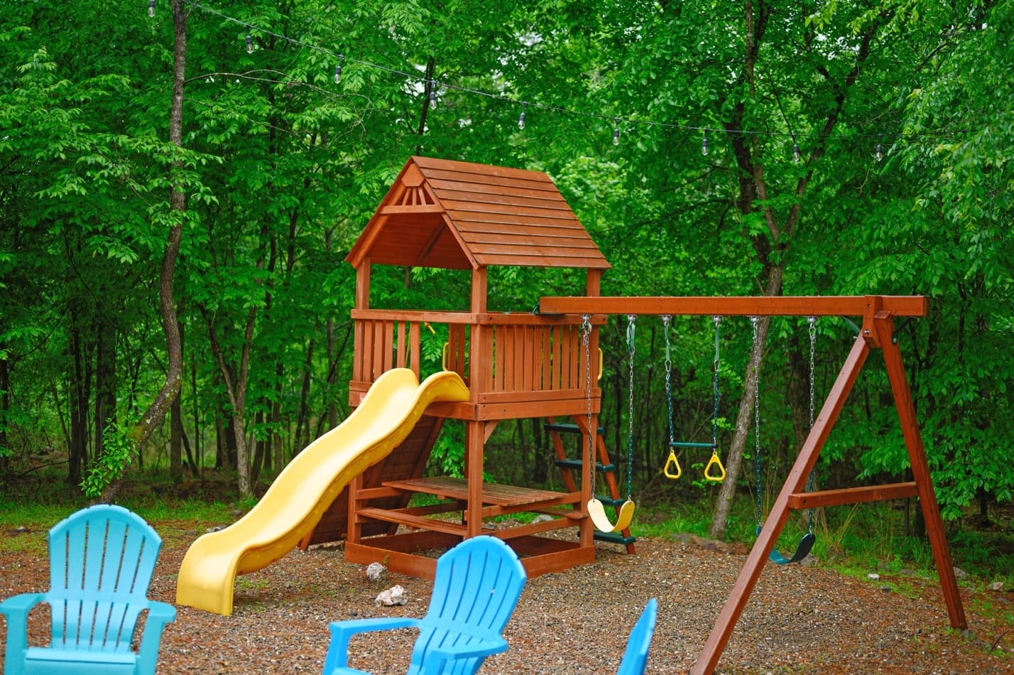 Wooden playground with a slide and swings